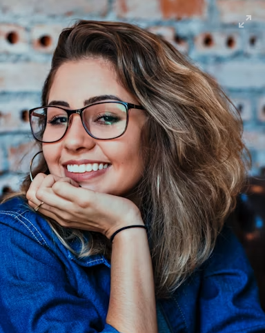 model with a blue shirt wearing eyeglasses