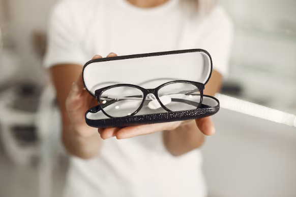 model holding prescription glasses in a case